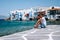 Young guy on vacation at the Greek Island of Mykonos, men relaxing at the little venice village of Mykonos Island