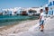 Young guy on vacation at the Greek Island of Mykonos, men relaxing at the little venice village of Mykonos Island