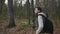 Young guy walking in the autumn woods and enjoying good weather.