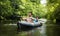 Young guys in boat with oars on river against background of green trees over water. Kayakers in kayak