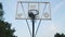 Young guys practice throwing the ball into the basketball hoop. Outdoor training. Team play. Hoop against the blue sky