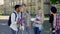 Young guys sincerely laughing on campus of college, multiethnic friendship