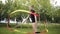 A young gymnast with ribbon performs exercises in the Park.