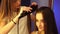 Young hair stylist make hairstyle with beautiful woman