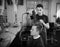 Young hairdresser dry hair to client in barber sh
