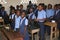 Young Haitian school girls and boys singing in classroom at school.