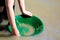 Young hands gold panning with a green pan