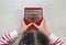 Young hands playing Kalimba Mbira or thumb piano lying on wood floor at home. African musical instrument