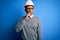 Young handsome african american engineer man with dreadlocks wearing safety helmet with hand on chin thinking about question,