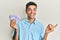 Young handsome african american man holding 20 swedish krona banknotes smiling happy pointing with hand and finger to the side