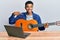 Young handsome african american man learning classical guitar from online tutorial pointing finger to one self smiling happy and