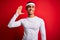 Young handsome african american sportsman wearing sportswear over red background Waiving saying hello happy and smiling, friendly