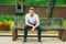 Young handsome American Man relaxing at street park in New York