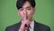 Young handsome Asian businessman with finger on lips