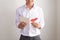 Young handsome asian man reads greeting card with heart shape on white background