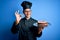 Young handsome baker man wearing cooker uniform and hat holding tray with cake doing ok sign with fingers, excellent symbol