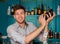 Young handsome barman in bar shaking and mixing alcohol cocktail