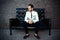 Young handsome bearded stylish man sitting on comfortable leather sofa