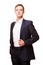 Young handsome businessman in black suit is standing straight and putting his hands in pockets, portrait isolated on