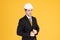 Young handsome businessman wears suit and construction helmet