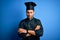 Young handsome chef man with beard wearing cooker uniform and hat over blue background skeptic and nervous, disapproving