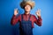 Young handsome chinese farmer man wearing apron and straw hat over blue background relax and smiling with eyes closed doing