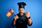 Young handsome cooker man with beard wearing uniform holding spain spanish flag annoyed and frustrated shouting with anger, crazy