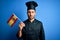 Young handsome cooker man with beard wearing uniform holding spain spanish flag with a confident expression on smart face thinking