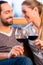 Young handsome couple drinking red wine