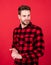 young handsome guy in red checkered shirt. stylish male wear casual clothes. bearded man with bristle on unshaven face