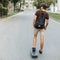 Young handsome guy rides on a snowboard. View from the back.