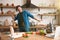 Young handsome happy man dancing in well-equipped modern kitchen while cooking tasty breakfast , sunday morning