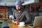 Young handsome hipster guy at the restaurant using a mobile phone.