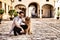 young handsome Hispanic man with his brown golden retriever dog, they are crouched down looking at the same place. Concept pets,