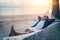 Young handsome Latin man in sunglasses relaxing in a hammock on the beach at sunset on the beach