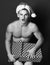 Young handsome macho surprised santa man with muscular athletic strong body has bare torso and strong belly in