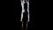 Young handsome male acrobat gymnast in white clothes on a black background makes jumps and shows tricks with rotation