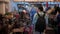 Young handsome man in an antique shop. Flea market in a tourist area. A tourist in the evening inspects