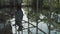 A young handsome man in an architect or lawyer suit walks around a modern office. Reflection in a glass table.