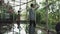 A young handsome man in an architect or lawyer suit walks around a modern office. Reflection in a glass table.