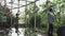 A young handsome man in an architect or lawyer suit walks around a modern office. Reflection in a glass table.