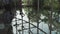 A young handsome man in an architect or lawyer suit walks around a modern office. Reflection in a glass table.