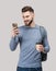 Young handsome man with backpack holding smart phone and coffee isolated portrait. Smiling student or businessman studio shot