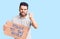 Young handsome man with beard holding power to the people cardboard banner annoyed and frustrated shouting with anger, yelling