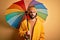 Young handsome man with beard wearing raincoat for rainy day holding colorful umbrella with a confident expression on smart face