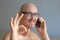 Young handsome man in black glasses is talking on the phone. Positive news.Portrait of a man close up. A man shows everything okay