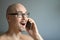 Young handsome man in black glasses is talking on the phone, smiling. Closeup portrait of a man. Manager, office worker, talking