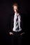 Young handsome man in a business suit and a white shirt and tie in formal style in the Studio on a black background