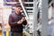 Young handsome man choosing wine in supermarket. Matter of wine choice