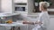 Young handsome man drinking coffee in kitchen in morning. Close-up of footage of Caucasian thoughtful guy looking out of